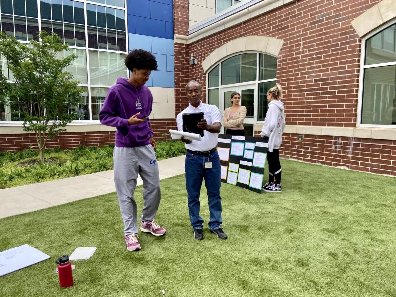 Jahden Cannon, left, and Rony Flechier go over assignments.